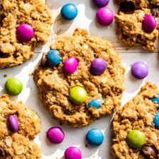 Monster Cookies on a white board with extra M & M's around them.
