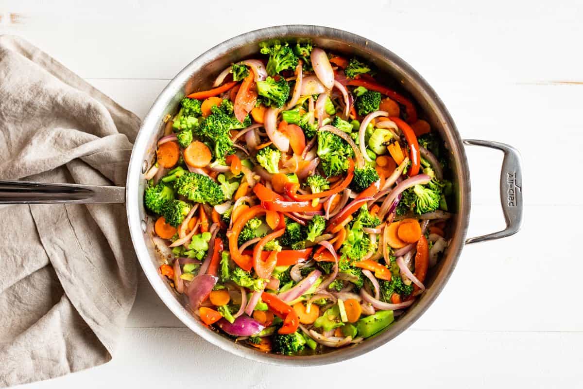 Sautéing the vegetables in a large skillet.