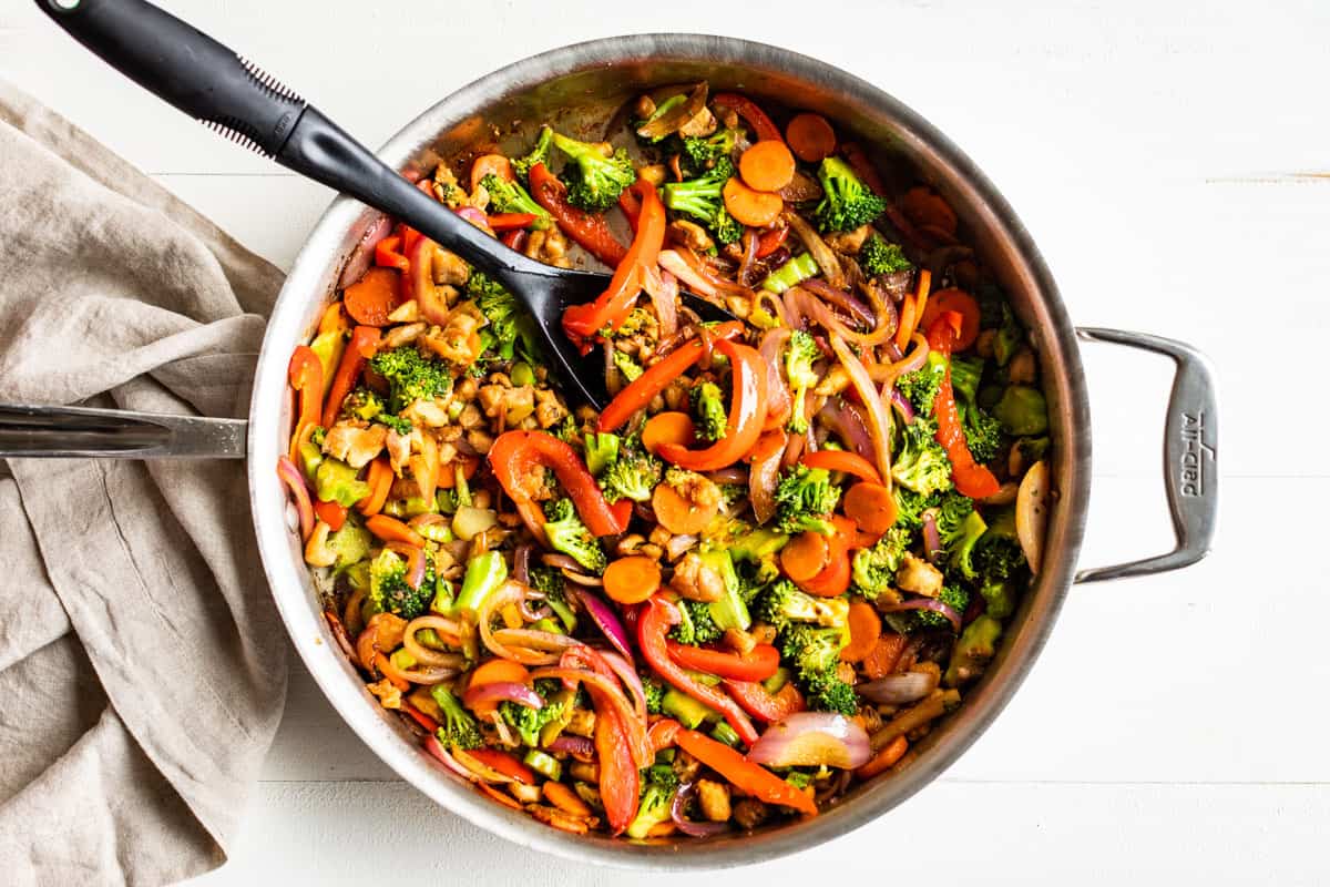 Adding the sauce to the chicken stir fry.