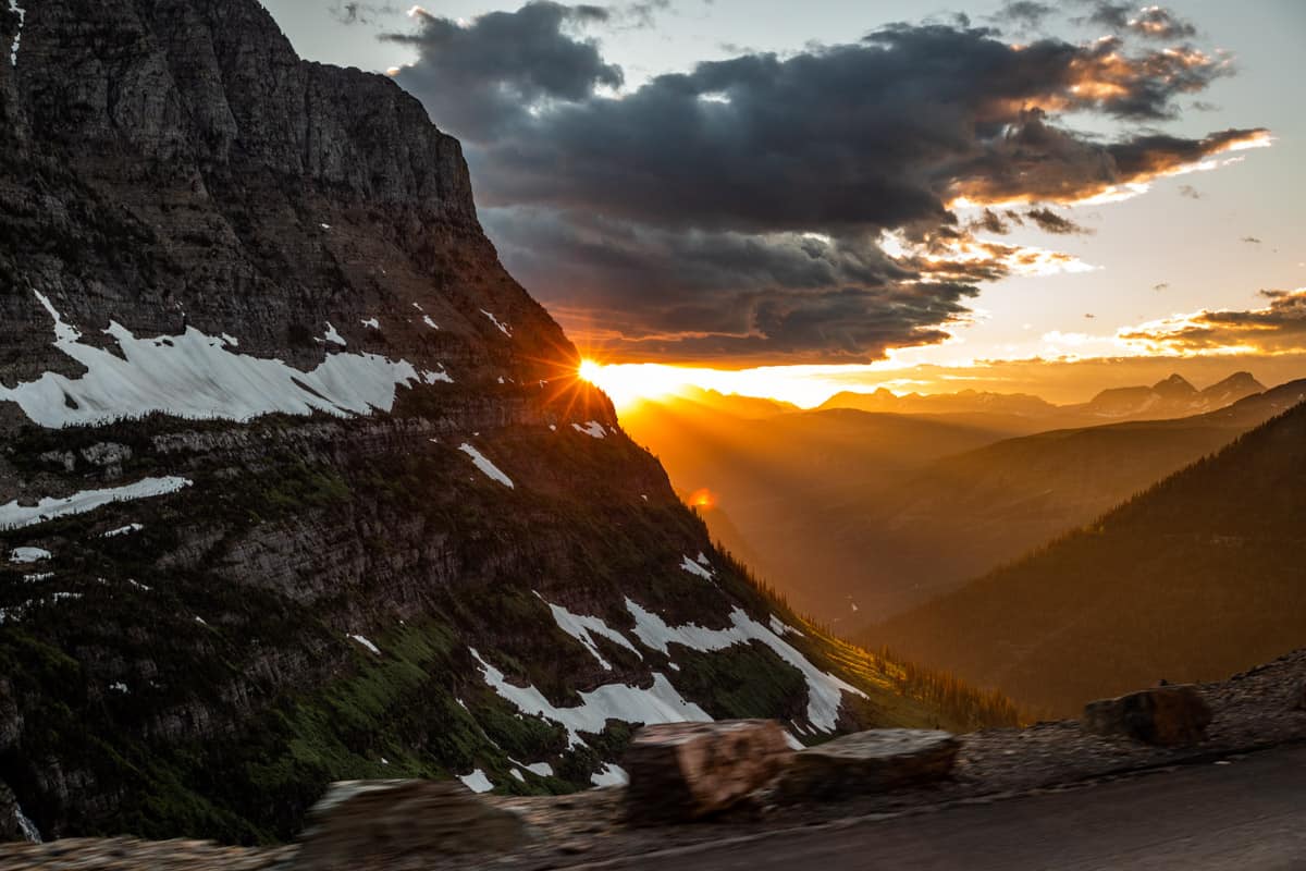 The sun setting behind a mountain.