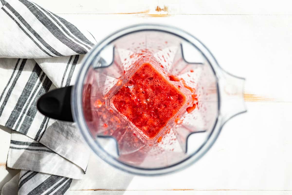 Blended up strawberry mixture in a blender container.