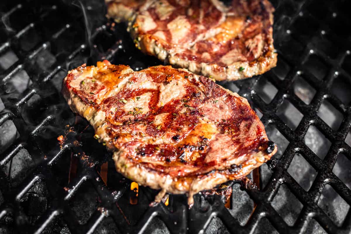 Turning over the Tuscan Steaks on the grill.