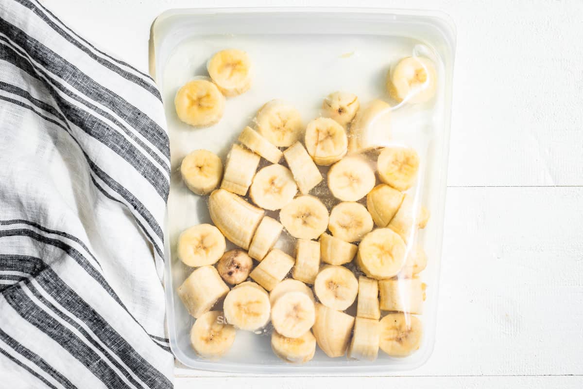 Frozen banana slices in a silicone Stasher bag.