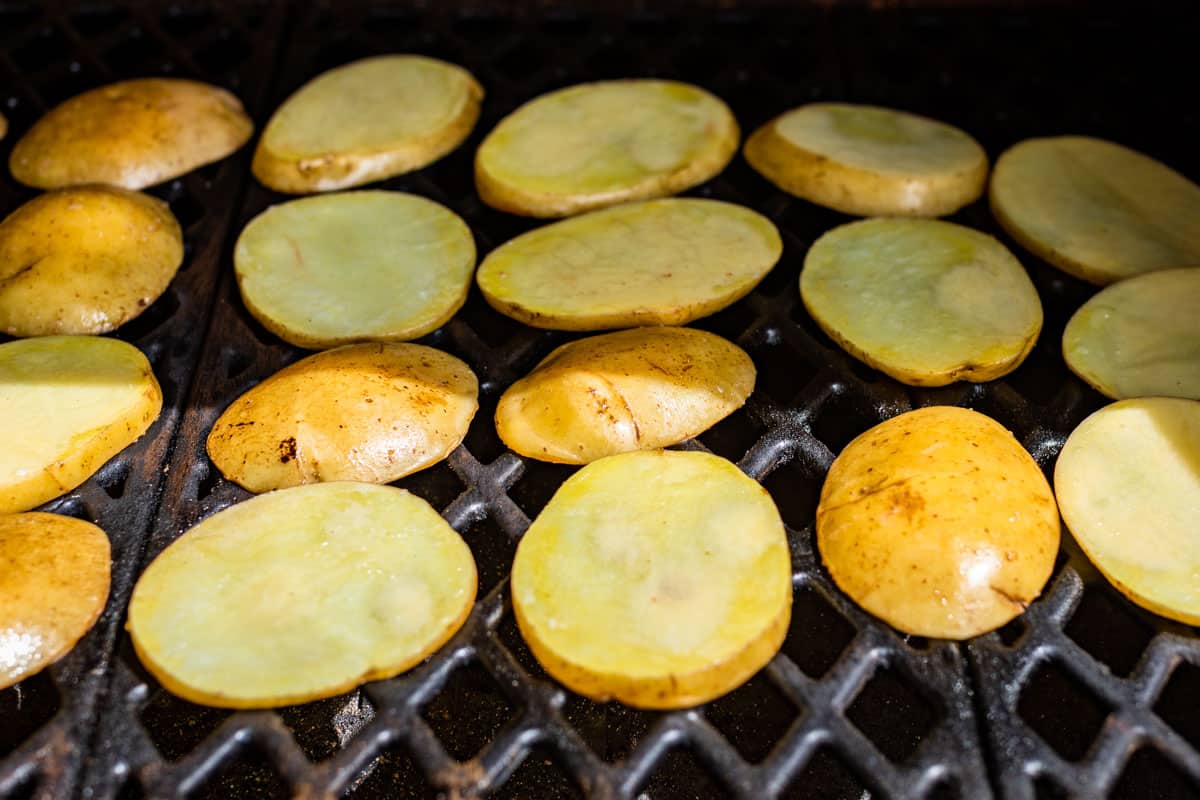 Sliced potatoes on the grill.