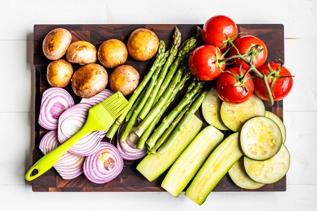 Brushing the veggies with garlic olive oil before grilling.