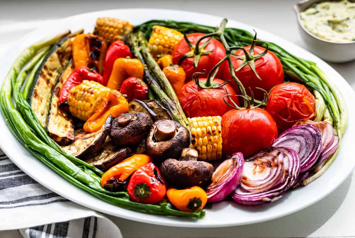 Side view of the Grilled Vegetables with a small bowl of Basil Aioli on the side.