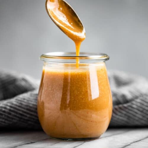 Finished Honey Mustard Sauce in a glass jar.