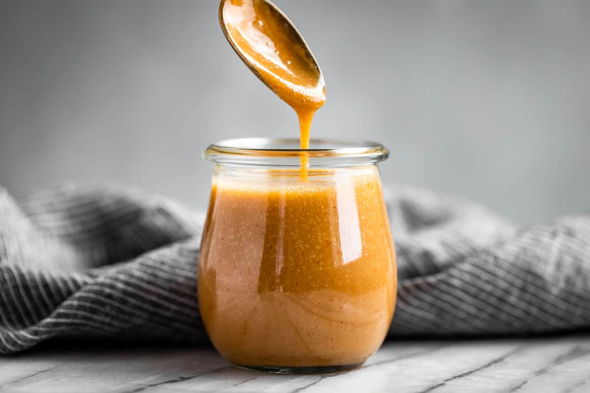 Finished Honey Mustard Sauce in a glass jar.