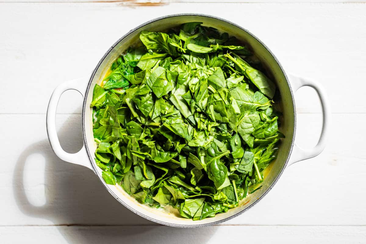 The final step adding the spinach to the Thai Green Curry.