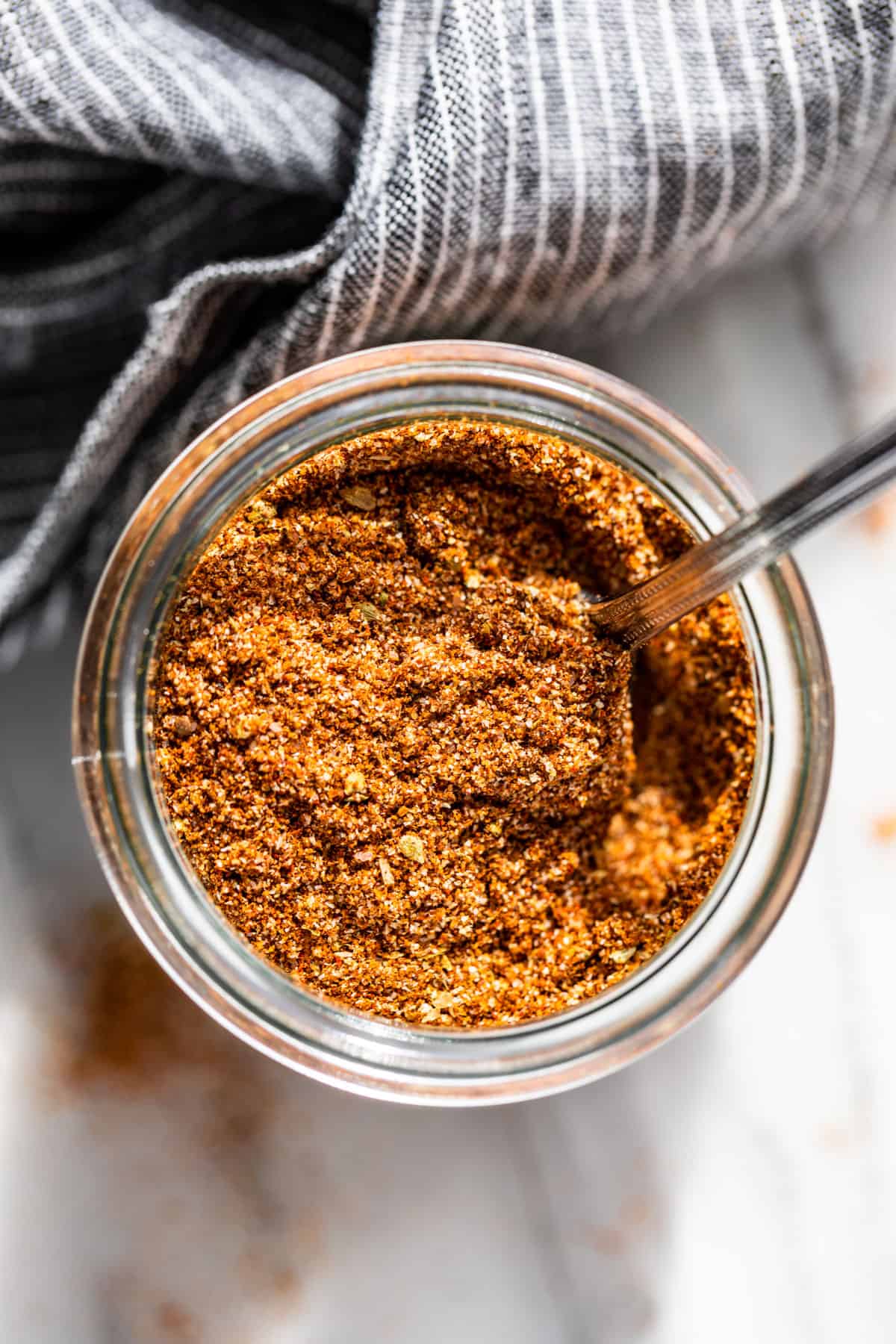 Straight down view of Fajita Seasoning in a glass jar.