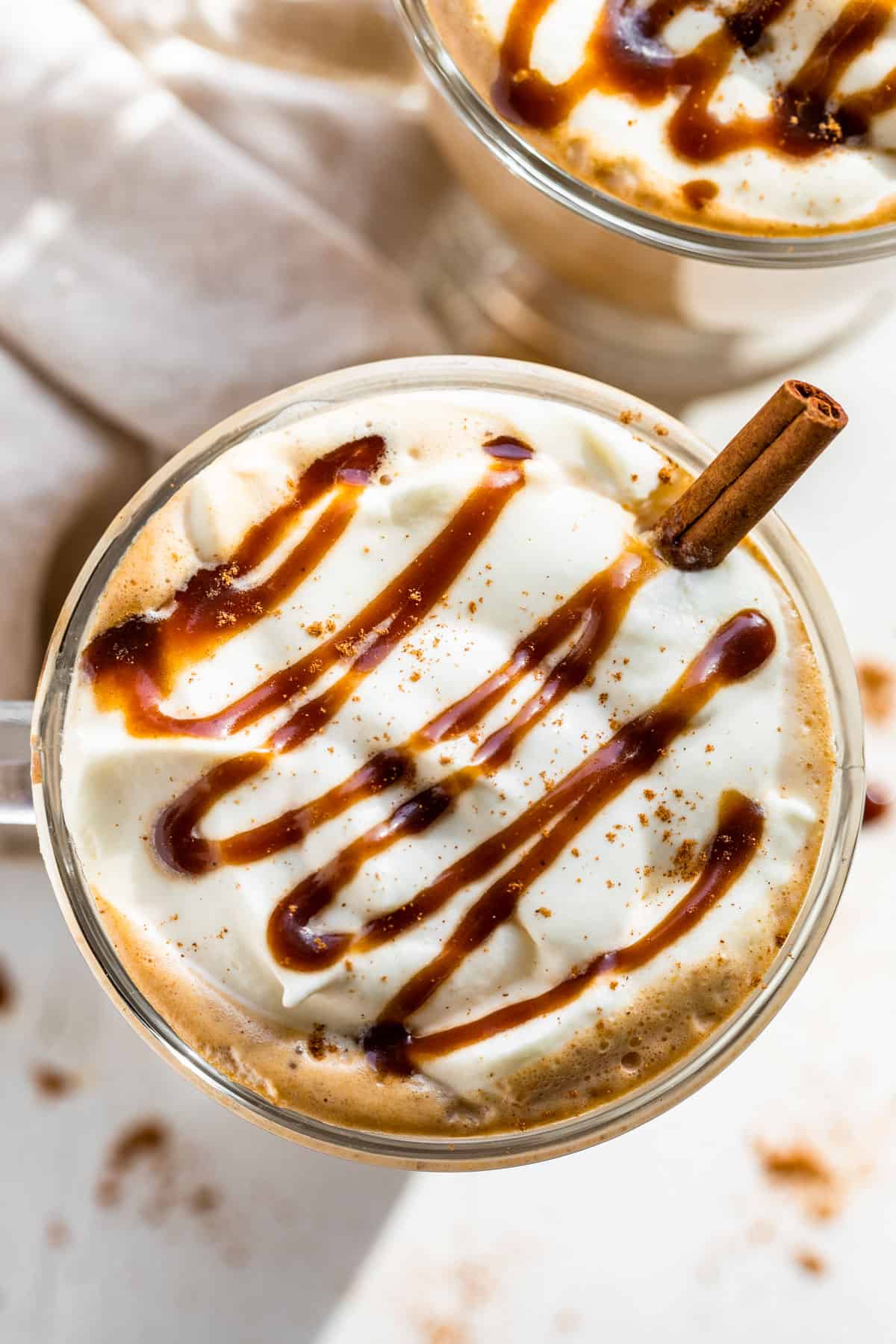 Straight down view of a caramel swirl over whipped cream topping the Pumpkin Chai Latte.