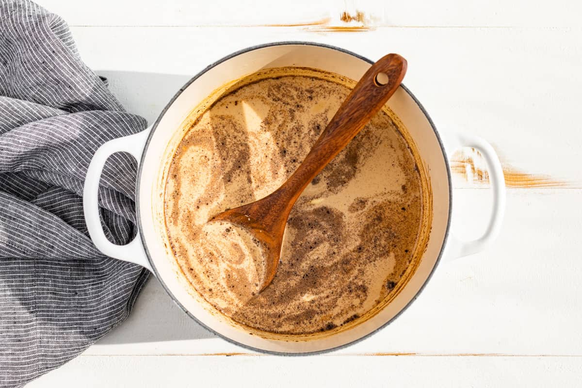 Mixing the milk into the pumpkin chai tea mixture.