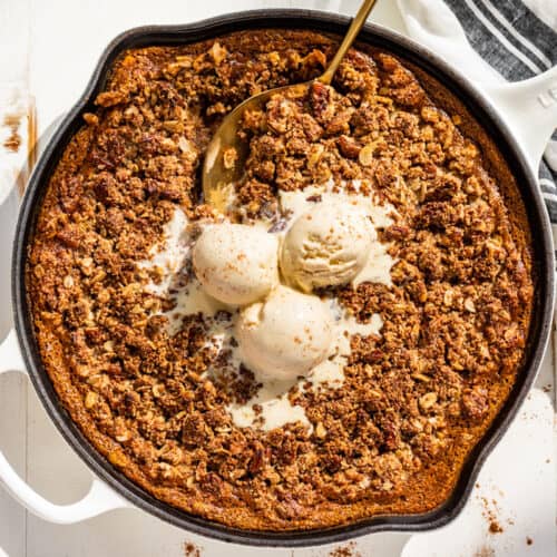 Downwards view of the finished Pumpkin Crisp topped with vanilla ice cream.