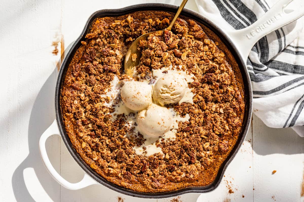 Downwards view of the finished Pumpkin Crisp topped with vanilla ice cream.