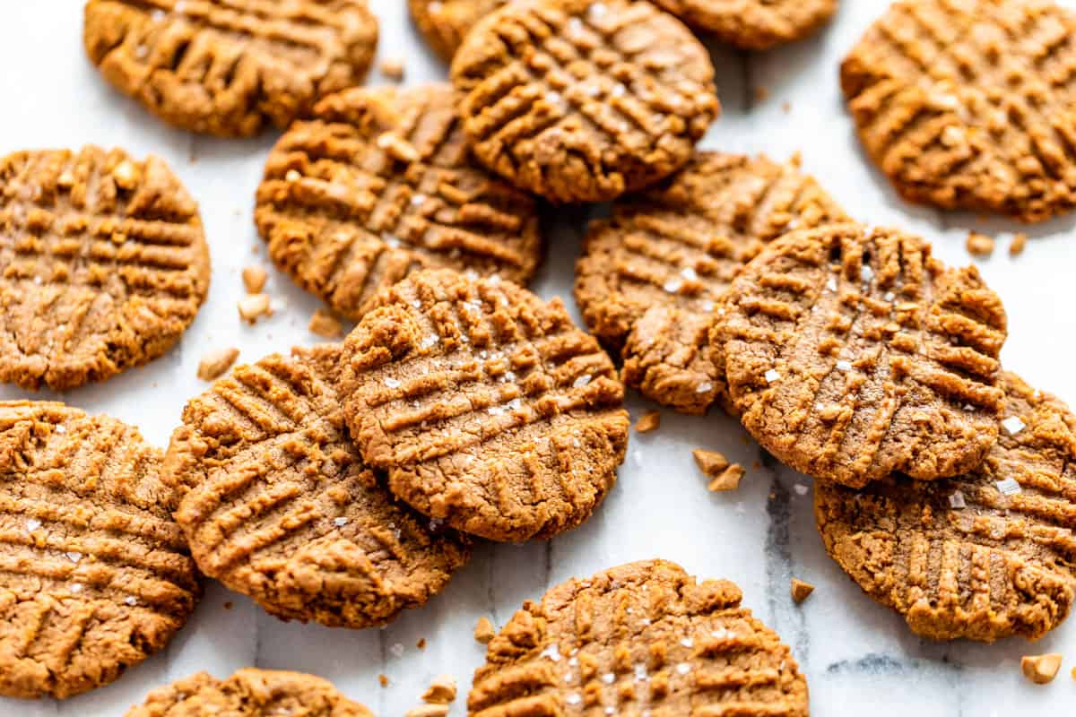 Peanut Butter Cookies stacked together on a marble background.