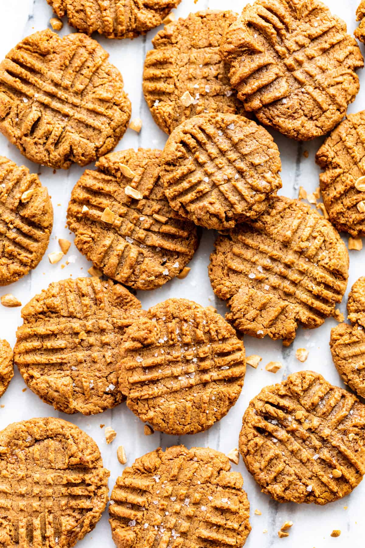 Straight down view of Peanut Butter Cookies stacked together on a marble background.