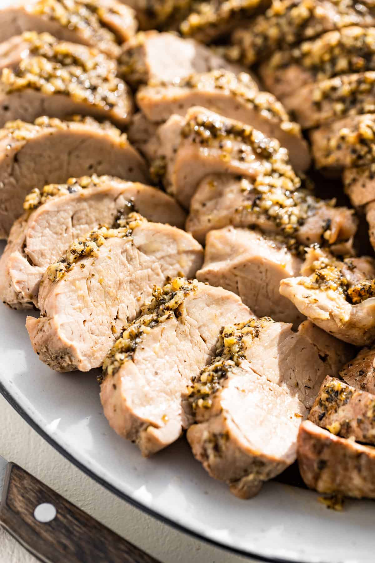 Close view of baked Pork Tenderloin on a serving platter.