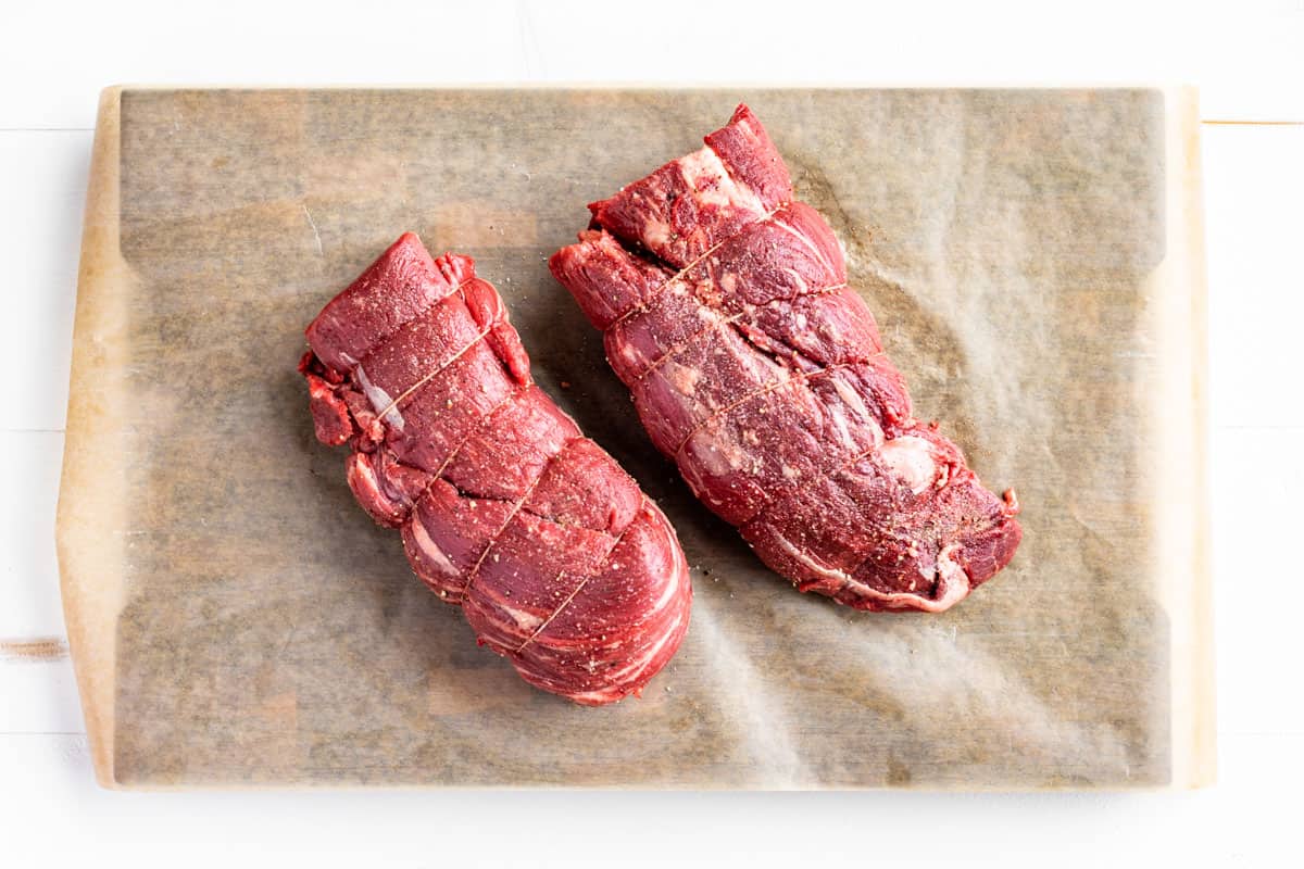 Seasoning the two Beef Tenderloin tied roasts with sea salt and pepper.