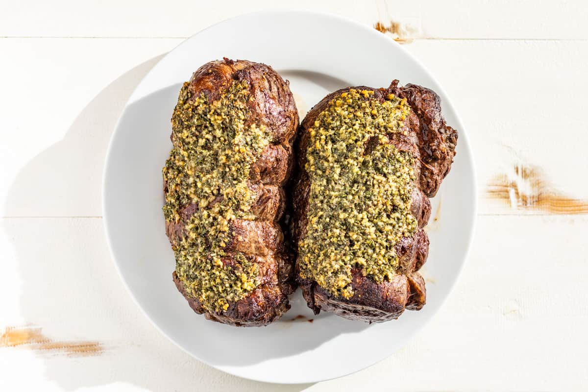 Finished Beef Tenderloin roasts removed to a plate to rest before slicing.