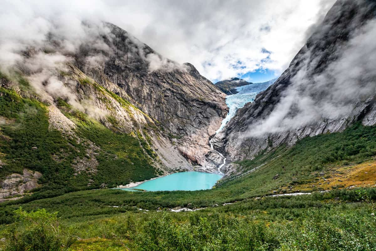 View of Briksdalsbreen glacier with a turquoise meltwater below it.