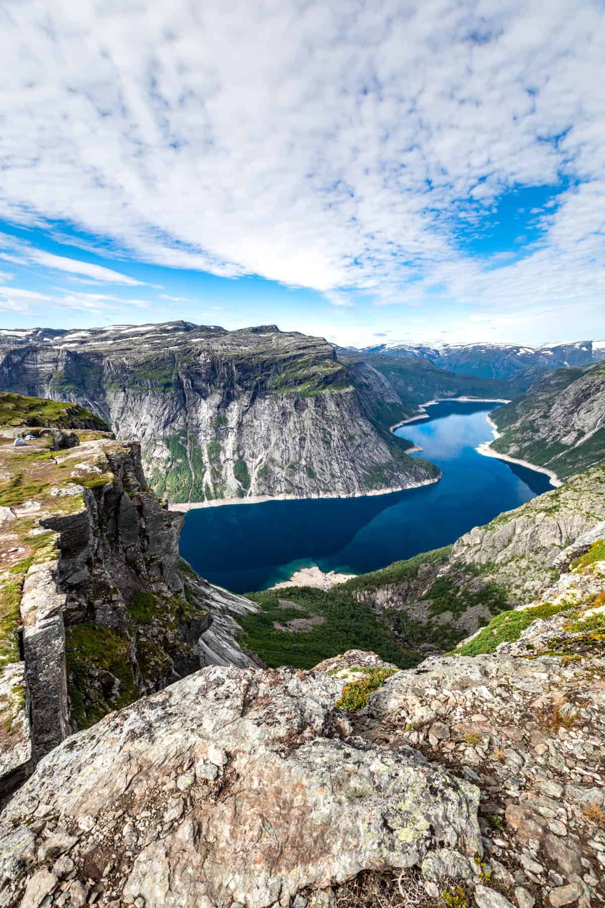 A view looking down the fjord with mountains around the water.