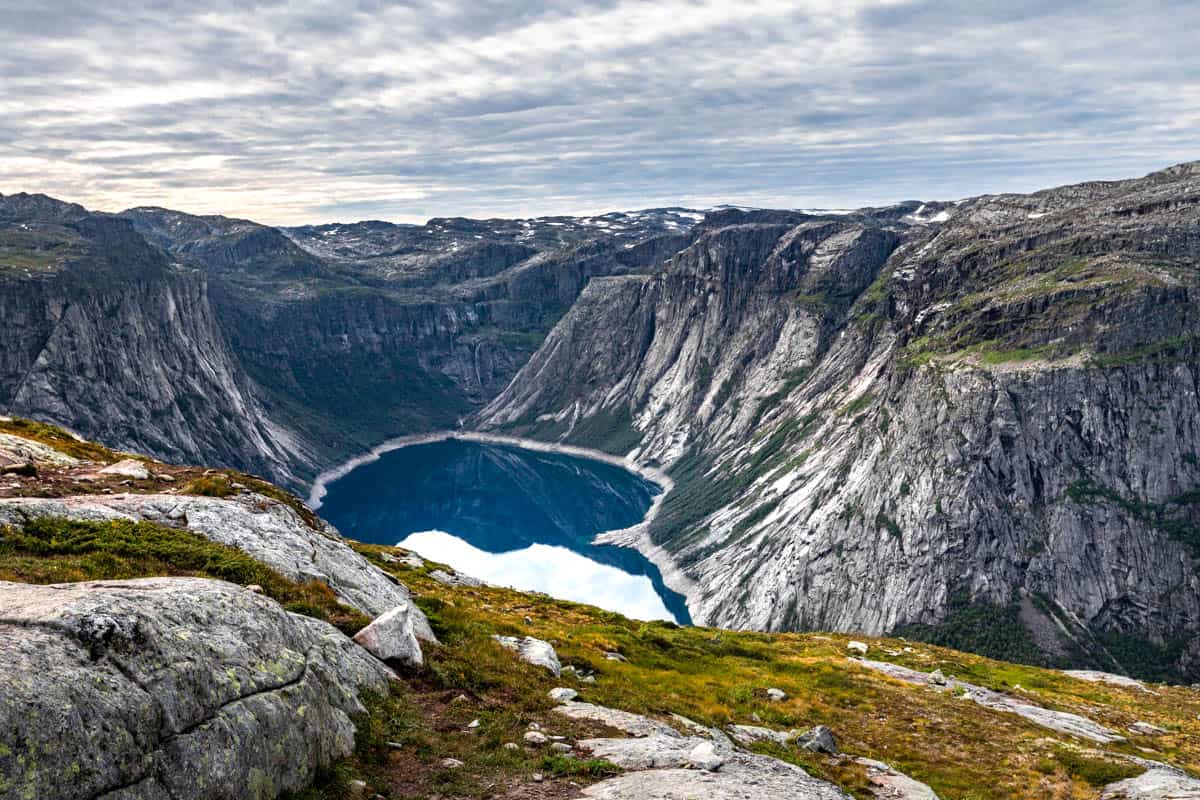 The end of a fjord with mountains surrounding the water.