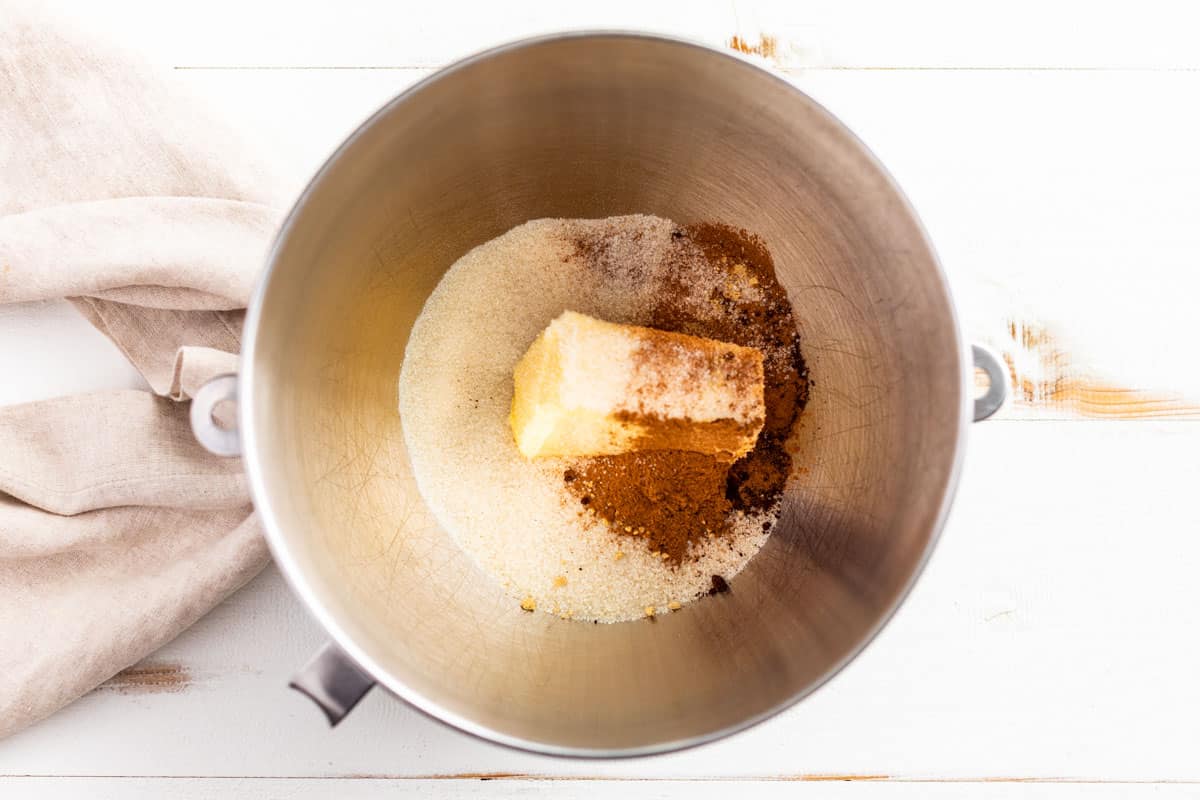 Adding the butter, sugar, and spices to a mixing bowl.