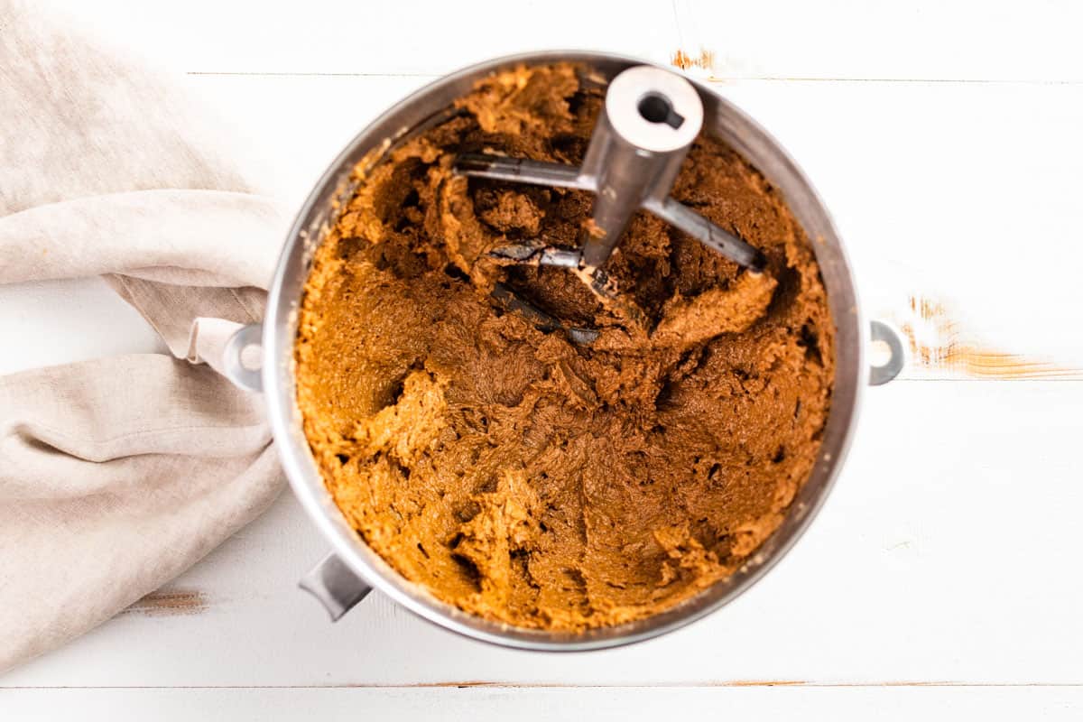 Creamed butter, sugar, and molasses in a mixing bowl.