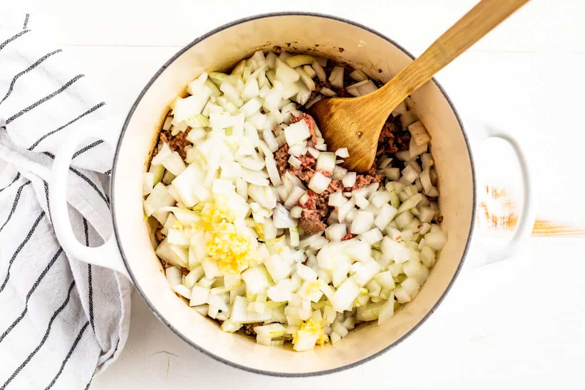 Sautéed ground beef with onion and garlic being added.