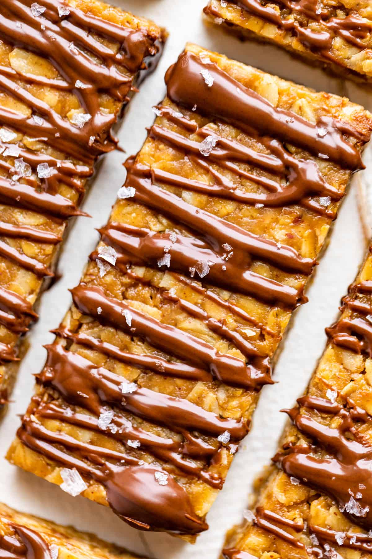 Close up view of a Peanut Butter Granola Bar drizzled with melted chocolate.