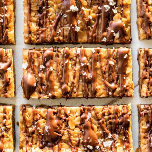 Finished Peanut Butter Granola Bars drizzled with chocolate and sprinkled with sea salt.