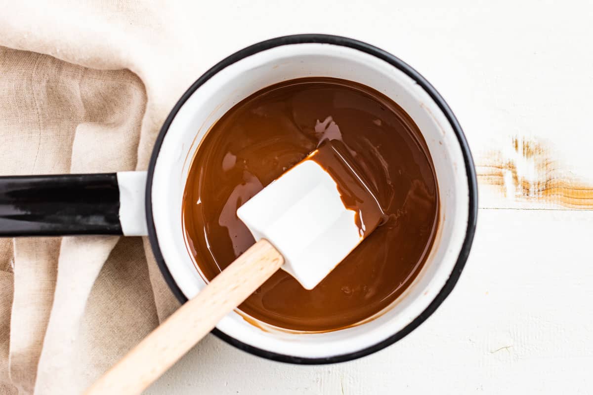 Melting chocolate and coconut oil together in a small saucepan.