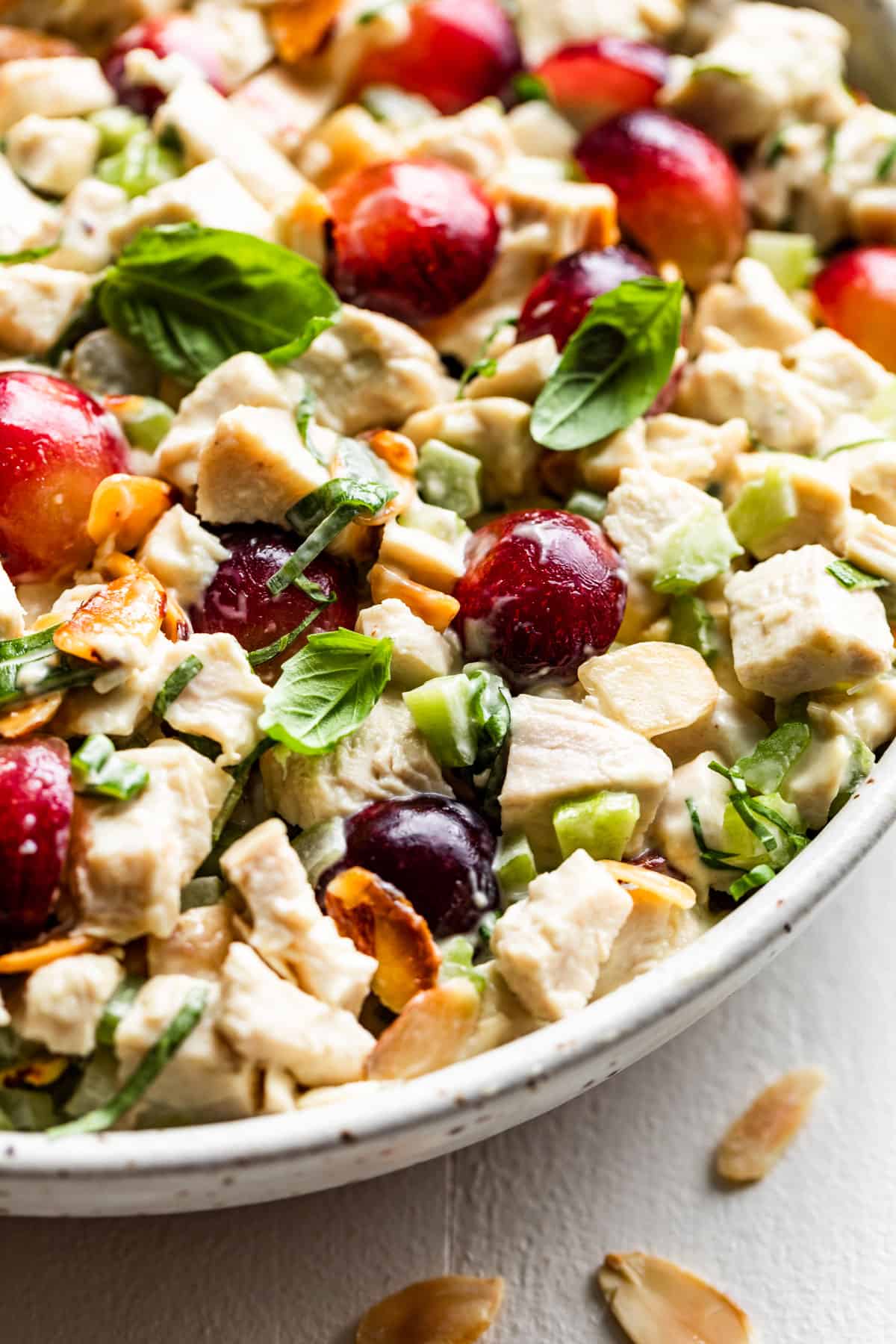 Chicken Salad with halved grapes in a pottery bowl.
