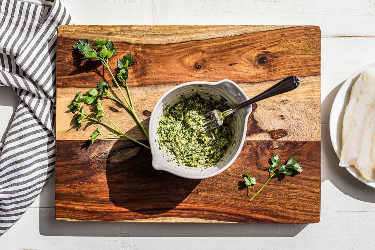 The herb butter mashed together and ready to be spread over the cod.