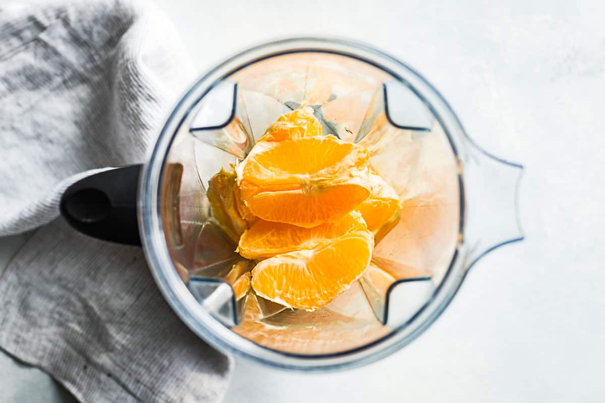 Oranges peeled and in the blender as the first step in making this recipe.