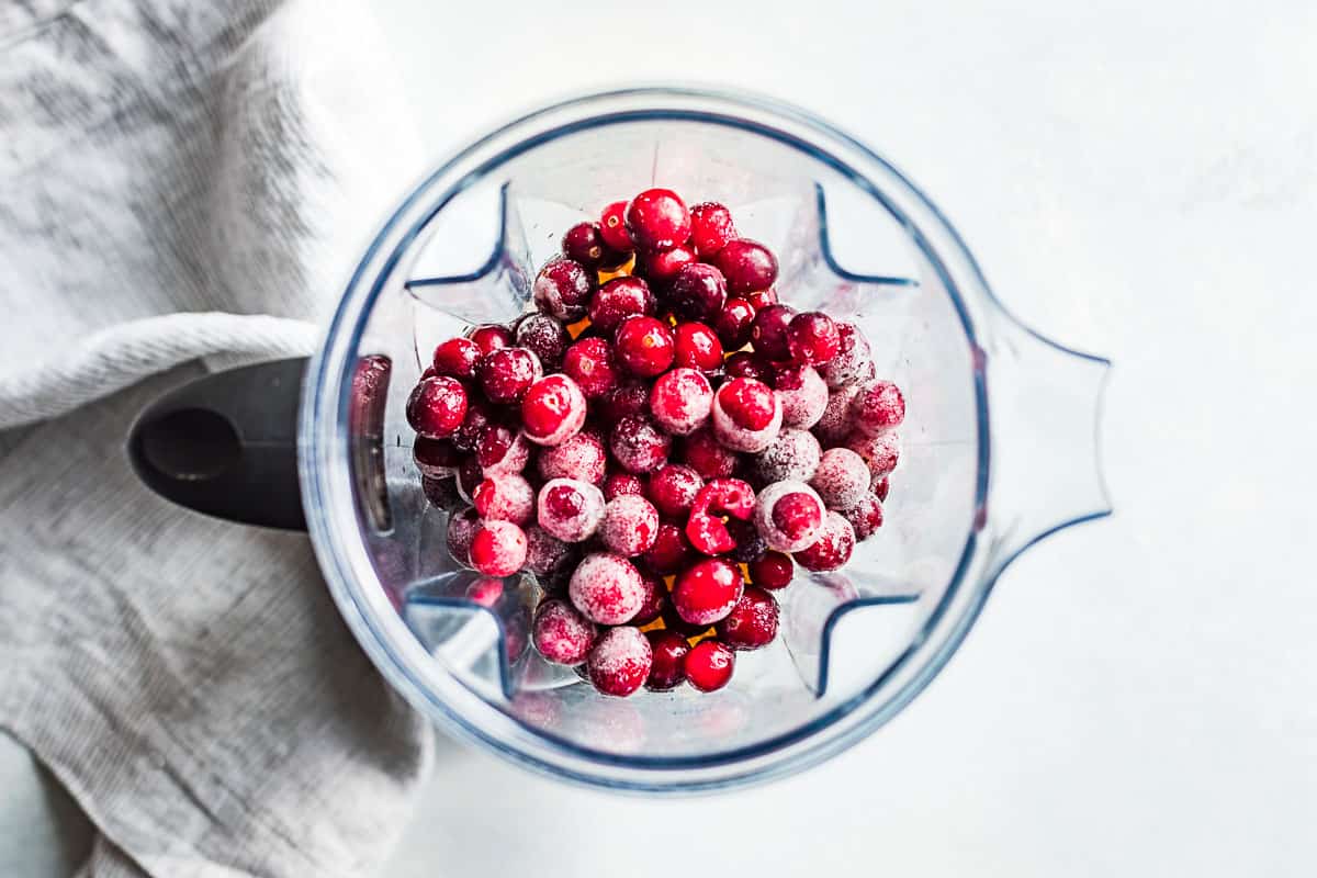 Frozen cranberries added into the blender on top of the oranges.