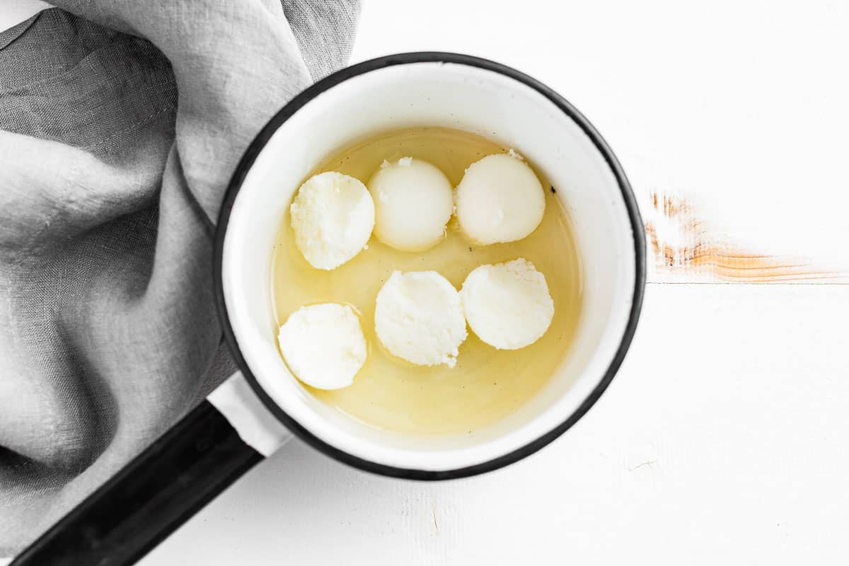 Shea butter and shea oil in a small saucepan.