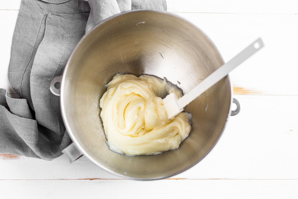 The chilled body butter being added to the mixing bowl.