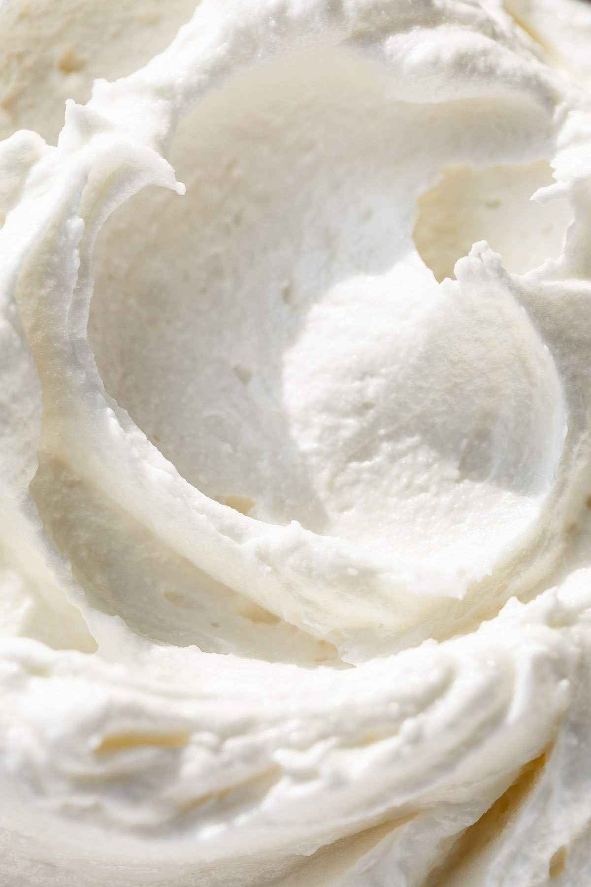 Close macro view of Whipped Body Butter with a swirl pattern in it.