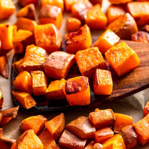 Finished roasted sweet potatoes with a wood spatula.