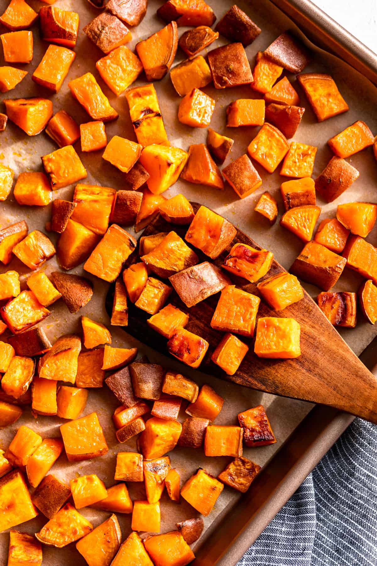 Straight down view of Roasted Sweet Potatoes on a baking sheet turned sideways.