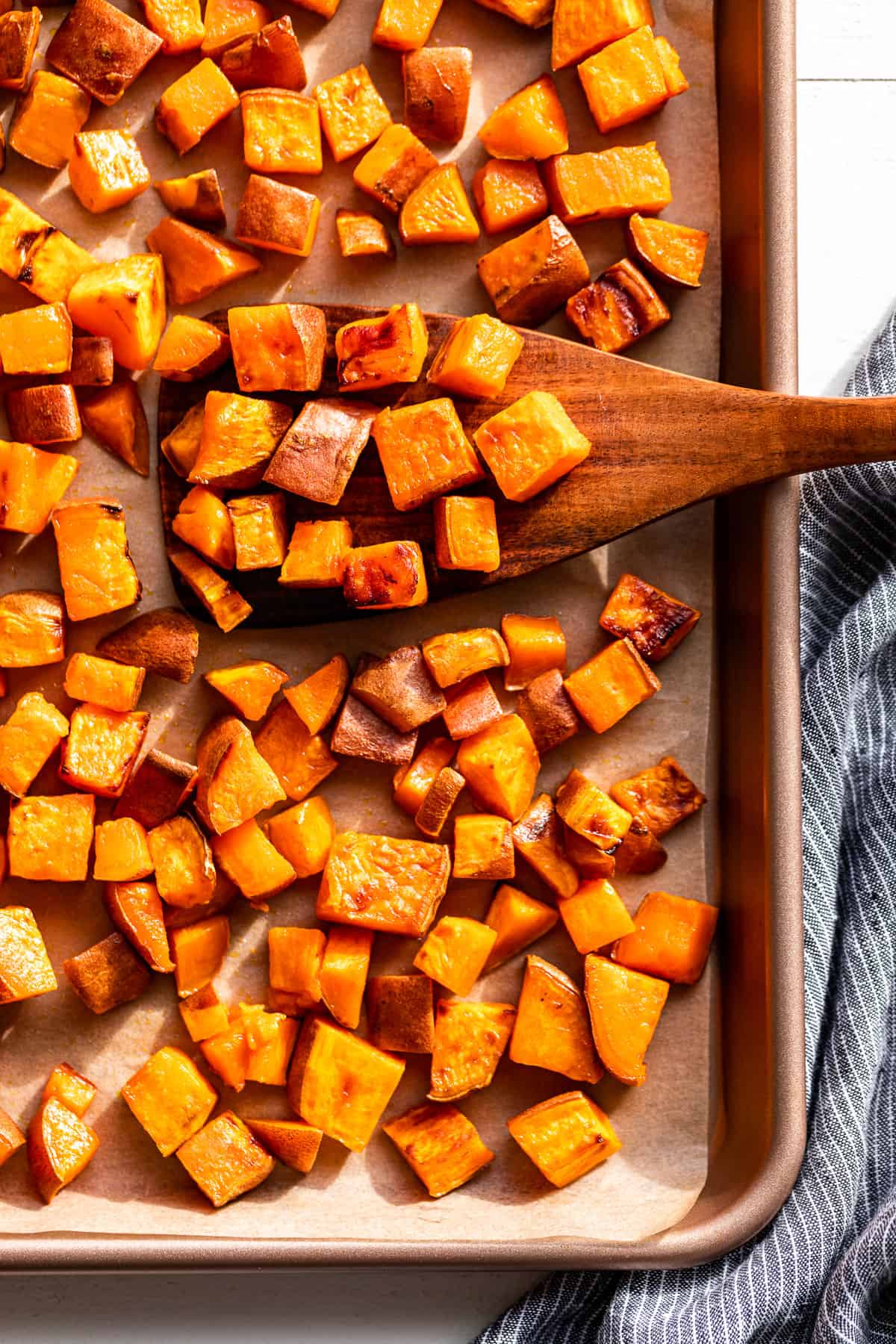 Straight down view of Roasted Sweet Potatoes on a baking sheet.