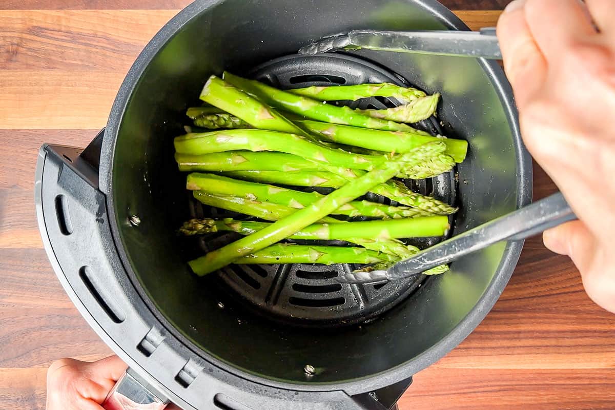 Tossing the asparagus with tongs halfway through the cooking time.