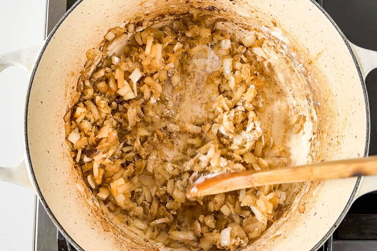 Cooking the onion and garlic together in a white Dutch oven.