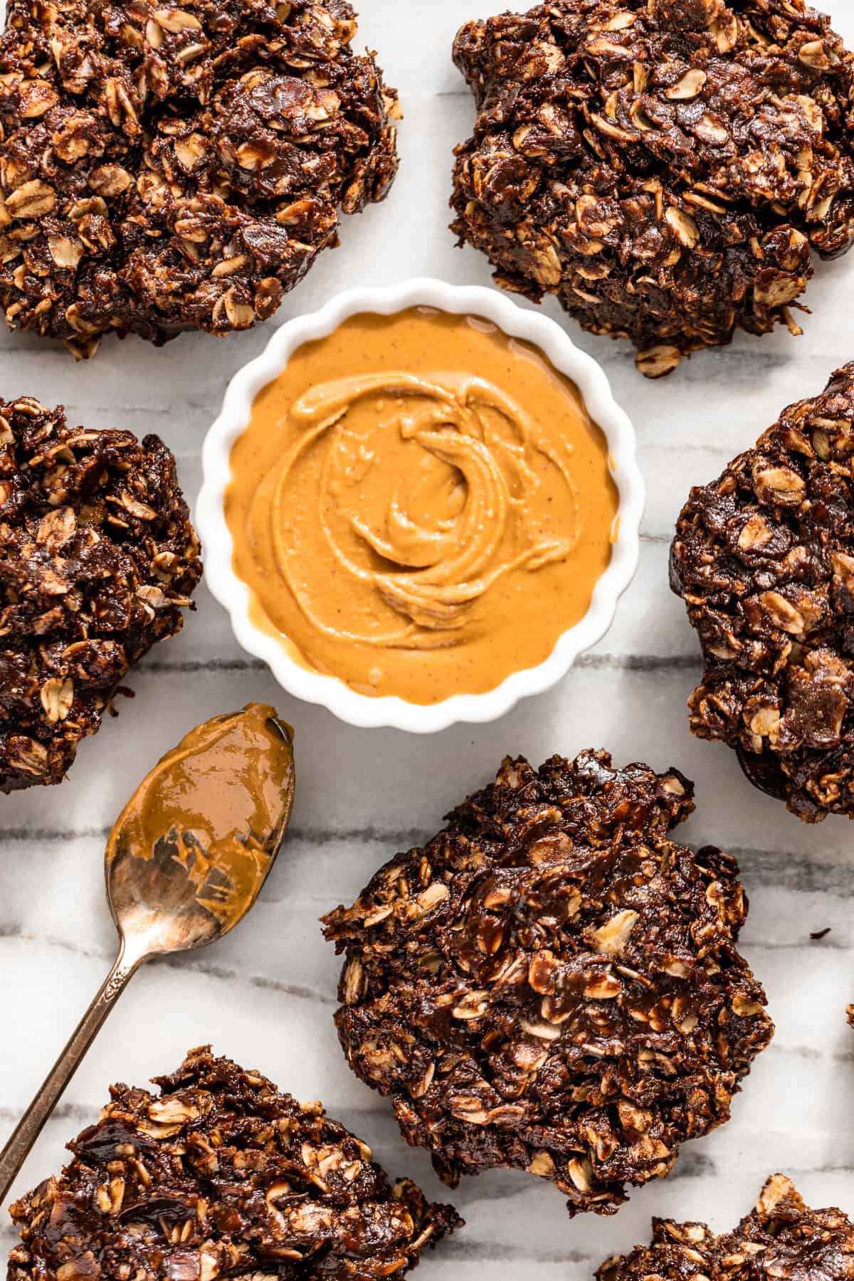 Healthy No Bake Cookies with a small bowl of peanut butter in the center.