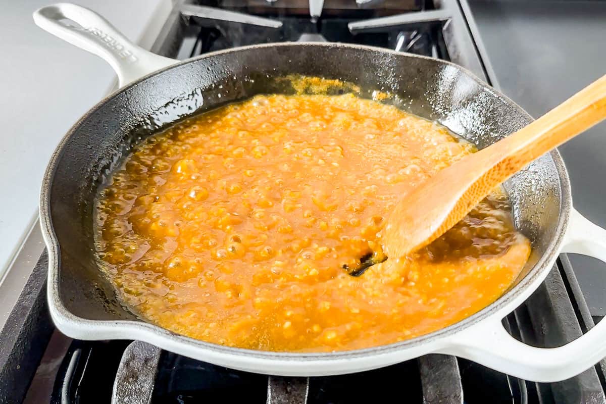 Reducing down the orange sauce before adding the chicken in.