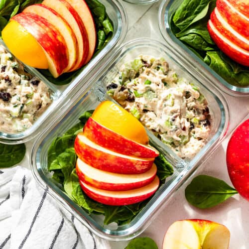 Straight down view of Healthy Tuna Salad in meal prep containers with apples on the side.