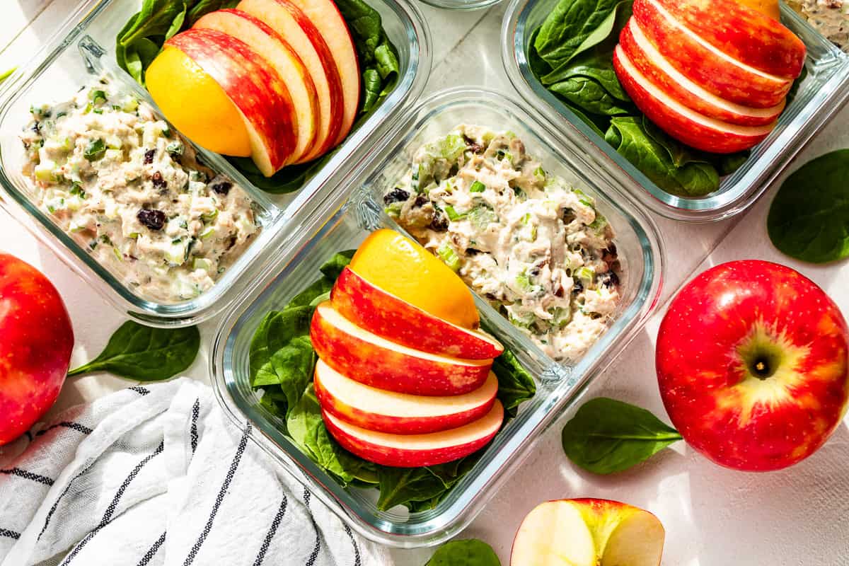 Straight down view of Healthy Tuna Salad in meal prep containers with apples on the side.