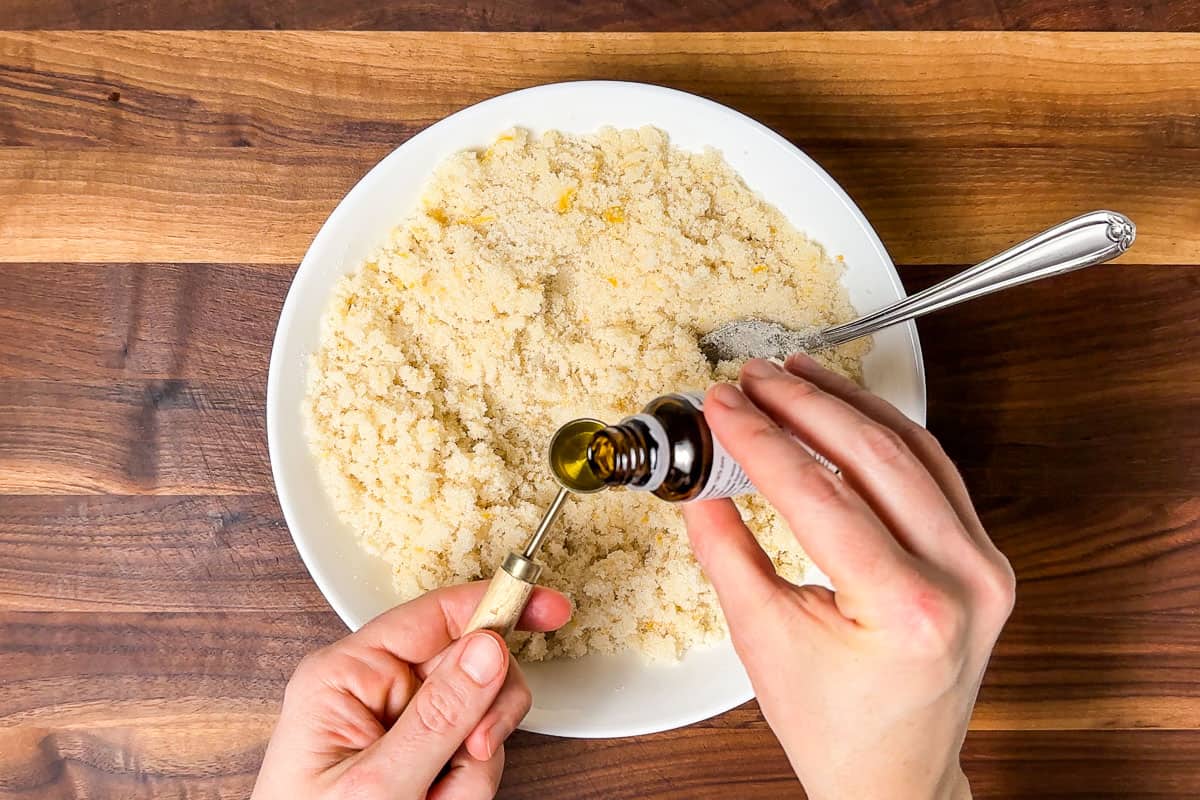 Adding the lemon essential oil to the sugar scrub.