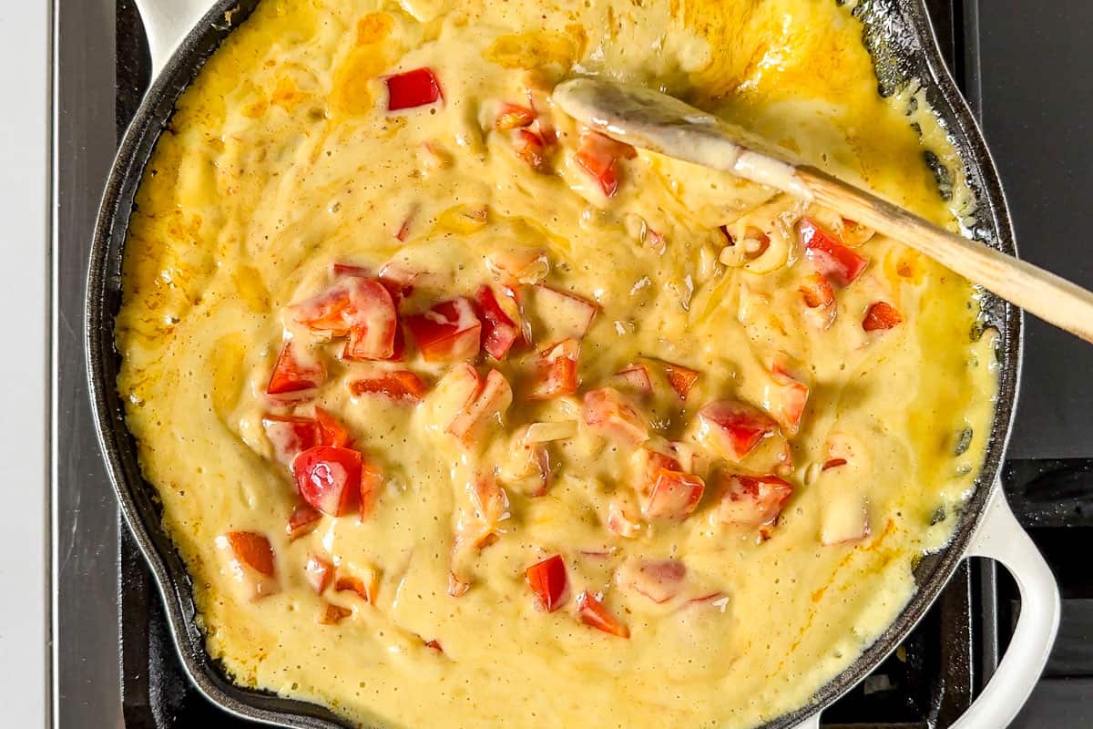 Simmering the coconut mango sauce together with the red bell pepper.